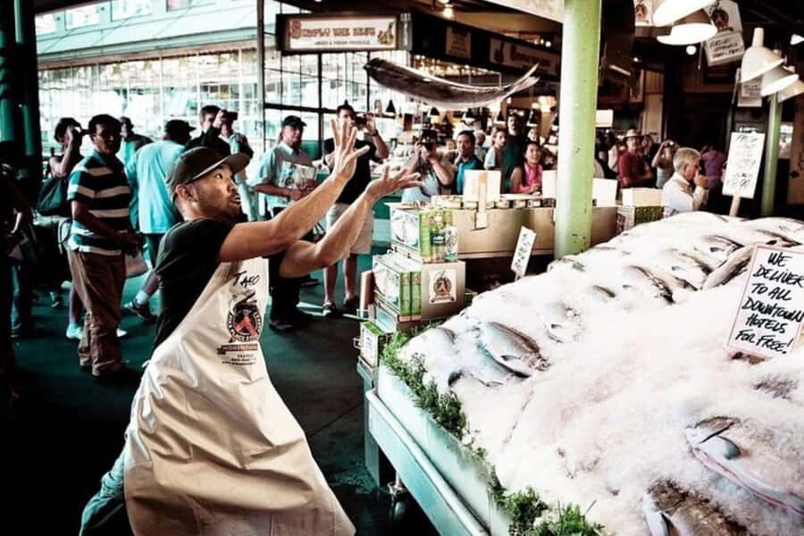 Secret Food Tours: Seattle Pike Place Market - Where You Start at Pike Place: Benches, a Wine Shop, and an Orange Umbrella